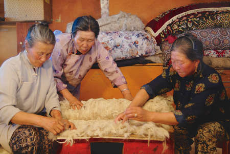 Harhorin, Mongolia - August 20, 2006: Senior Mongolian women produce in Harhorin, Mongolia. Felt is the essential material for yurt insulation and winter clothes in Mongolia.のeditorial素材