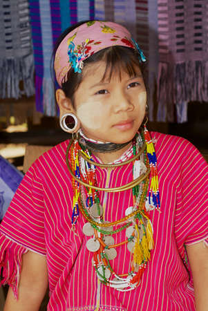 Mae Hong Son, Thailand - November 17, 2008: Portrait of a teenager girl of the Lahwi Padaung (Long Neck) hill tribe wearing traditional decorations in Kayan village in Mae Hong Son, Thailand.のeditorial素材