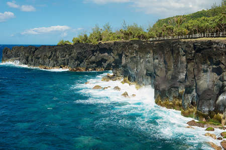 Black volcanic lava sea coast at Reunion island, France.の写真素材