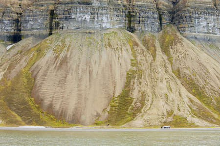 View to the cliffs the arctic shore of the polar archipelago of Spitsbergen near Longyearbyen, Norway.の写真素材