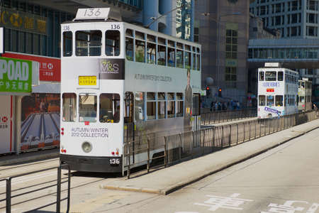 Hong Kong, China - September 17, 2012: Double-decker tram passes by the street in Hong Kong, China. The Double-deck trams system in Hong Kong is one of the most famous in the world.のeditorial素材
