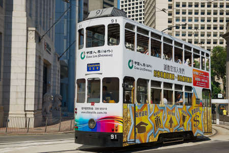 Hong Kong, China - September 17, 2012: Double-decker tram passes by the street in Hong Kong, China. The Double-deck trams system in Hong Kong is one of the most famous in the world.のeditorial素材