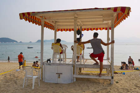 Hong Kong, China - September 16, 2012: Unidentified life guards on duty at Stanley town beach in...