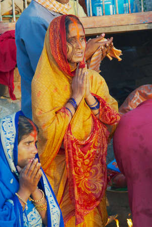 Varanasi, India - March 25, 2007: Unidentified woman pilgrim prays at the bank of the Holy Ganges...