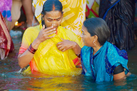 Varanasi, India - March 25, 2007: Unidentified pilgrims bathe in Holy Ganges river at sunrise in Varanasi, India.のeditorial素材