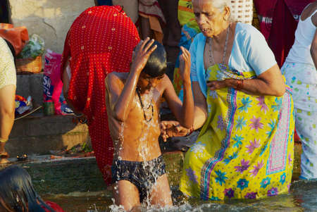 Varanasi, India - March 25, 2007: Unidentified pilgrims bathe in Holy Ganges river at sunrise in Varanasi, India.のeditorial素材
