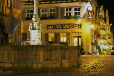 Rothenburg Ob Der Tauber, Germany - September 06, 2010: Historic buildings with a fountain at the forefront at night in Rothenburg Ob Der Tauber, Germany.のeditorial素材