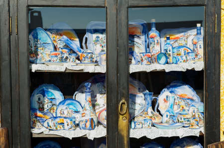 Oia, Greece - August 02, 2012: Traditional handmade souvenirs from Santorini island at the shelf of a street souvenir shop in Oia, Greece.のeditorial素材