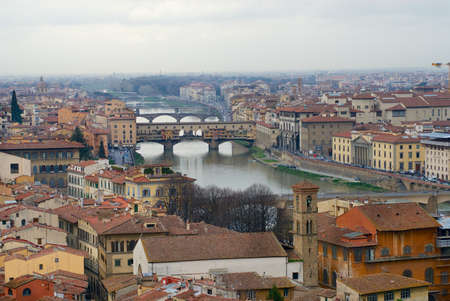 Florence, Italy - March 03, 2007: Cityscape of Florence on a cloudy day with the Ponte Vecchio bridge across Arno river in Florence, Italy.のeditorial素材