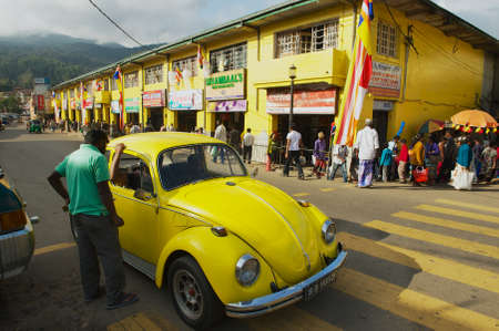 Kandy, Sri Lanka - May 21, 2011: Unidentified people in a vintage Volkswagen Beetle car pass by the street of Kandy, Sri Lanka.のeditorial素材