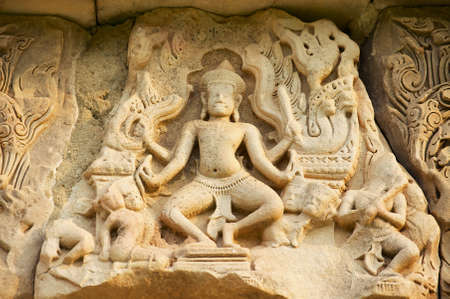 Sandstone carving with religious motifs at the ruins of the Hindu temple in Phimai historical park...