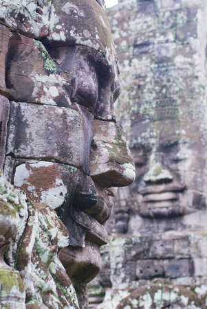 Stone carved faces at the wall of the Bayon temple in Siem Reap, Cambodia.の写真素材