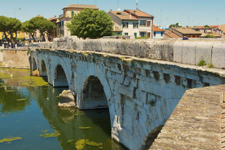Rimini, Italy- May 13, 2013: Historical roman Tiberius bridge over Marecchia river in Rimini, Italyのeditorial素材