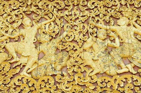 Luang Prabang, Laos - April 14, 2012: Elaborate wood carving at the exterior wall of Xieng Thong...
