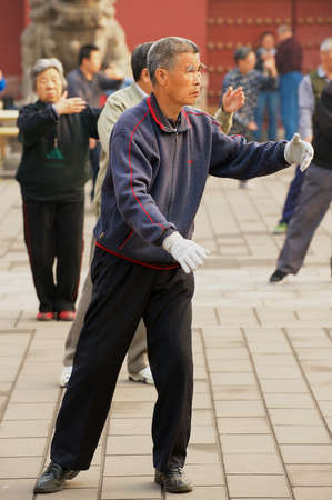 Beijing, China - May 01, 2009: Group of senior people practice tai chi chuan gymnastics outdoors in Beijing, China.のeditorial素材