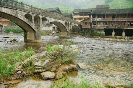 Longsheng, China - May 06, 2009: Traditional stone bridge across the river in Longsheng, China.のeditorial素材