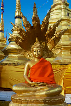 Buddha statue in red at Wat Boromthat temple in Tak, Thailand.の写真素材