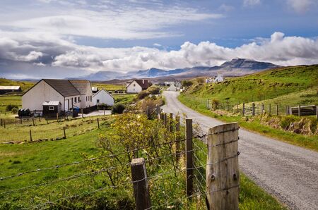 Scottish village, rural houses, Scotland, Isle of Skye Quiraing mountain. Great Britain