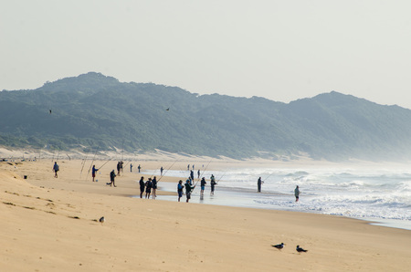 Pople fishing at St Lucia estuary beach, Isimangaliso wetland. Indian Ocean South Africaの写真素材