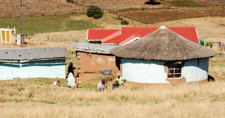South african family near a traditional mud house in small village, South Africa, apartheid, zululand KwaZulu Natalのeditorial素材