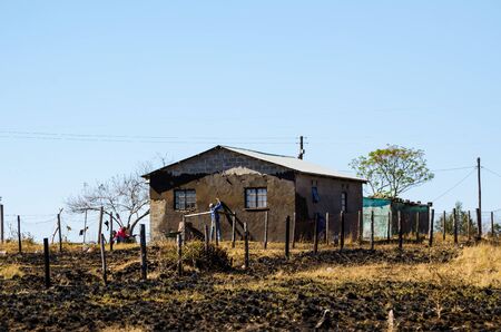 Man working building mud house, South africa, apartheid, zululand KwaZulu Natalのeditorial素材