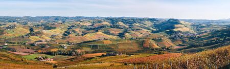 Panoramic hilly landscape to the Langhe vineyards in autumn. Viticulture of Dolcetto, Nebbiolo, Barbera, Barolo red wine. Tourism in Europe, travel destination. Piedmont, Italy.の写真素材
