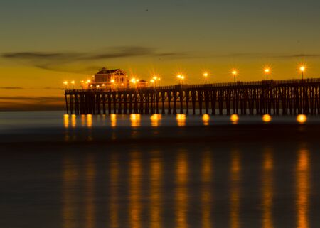 Sunset at Oceanside California pier showing the resturant at the end of the pier.の写真素材