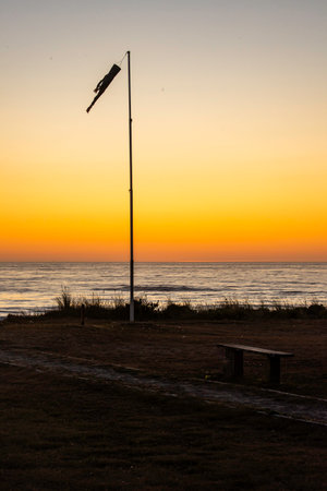 Beach Sunset with a windsock silhouetted.の写真素材