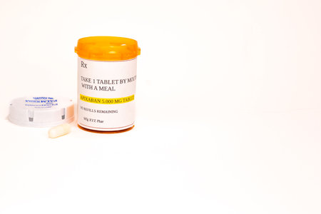 A container of prescription APIXABAN with one capsule in front of it. Level view.の写真素材