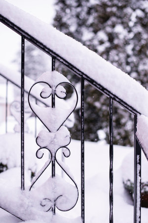 Heavy snow on a residentil porch railing piling up on the decorative work.の写真素材