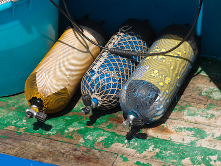 aqualungs on wooden deckの写真素材