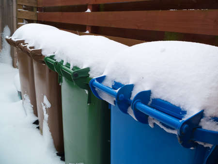 snow covered recycle binsの写真素材