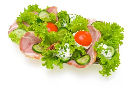 smoked meat, tomatoes and lettuce stuffed with cheese isolated on whiteの写真素材