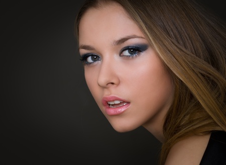 Attractive young fashion model posing in black dress の写真素材