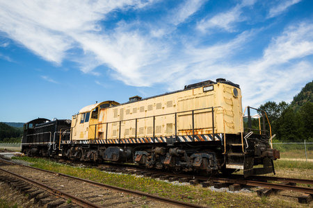 Two old enginge sit in an old railyard in Washington. The engines are still used around the yard but are worn down ad rusty.の写真素材