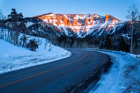 Road traveling toward desert sandstone formations near Bryce Canyon and Cedar Breaks in Southern...