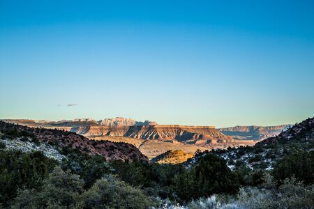 Looking out from the snow covered Pine Valley Mountains in Southern Utah. The skyline of Zion...