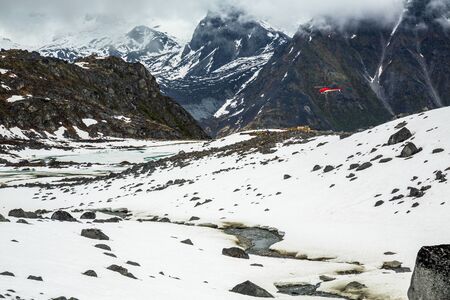 A helicopter drops off construction materials for a backcountry hut to be constructed in the remote...