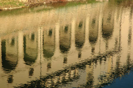 Columns of classical building reflected on surface of waterの写真素材