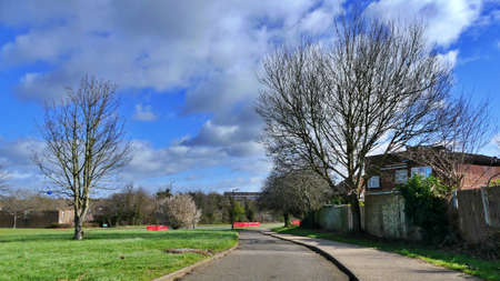 Harlow, England - 13 March 2019. A potholed path leading past a housing estate
