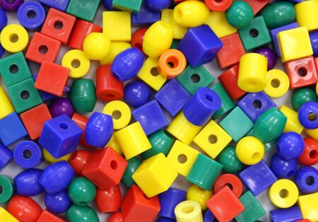 several colored craft beads make a colorfull backgroundの写真素材