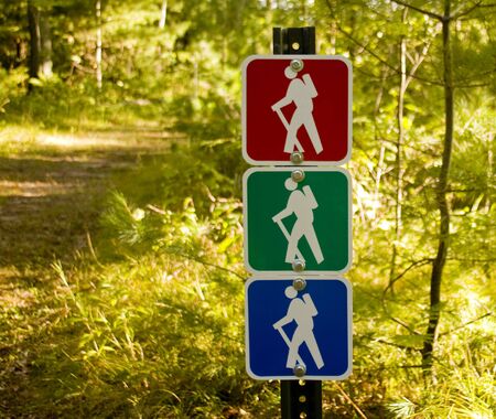 Hiking trail sign marking a path through the forest