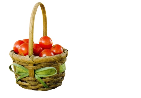 basket full of cherry tomatoes isolated over a white backgroundの写真素材