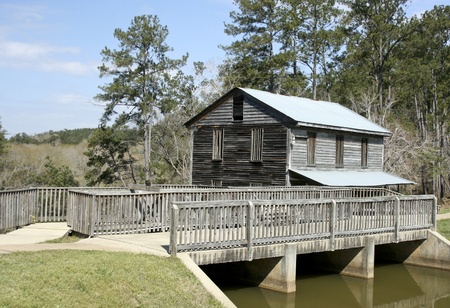 vintage river mill with trees in the backgroundのeditorial素材