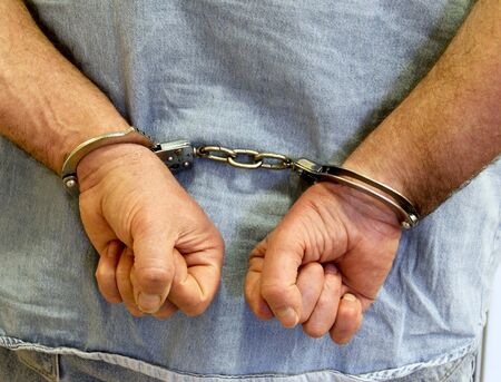 man handcuffed with his hands behind his back