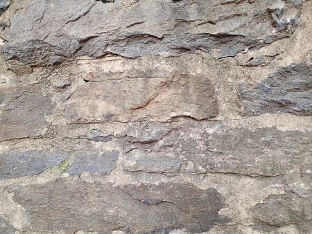 Old stone wall background made from rocks and cement