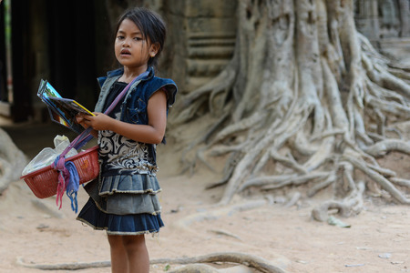 Angkor Wat, Siem Reap, Cambodia - March 30, 2013   A little girl selling her post card のeditorial素材