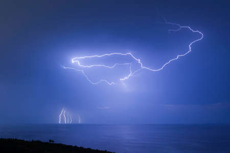 Curved lightning in the sky over the Black sea in Crimeaの写真素材