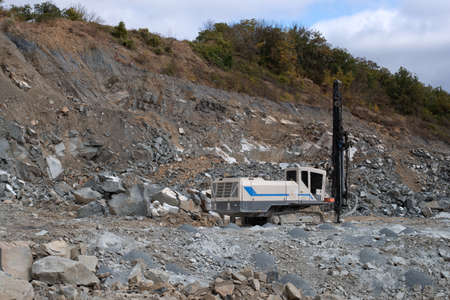Drilling rig prepares blasting operations in a stone quarryの写真素材
