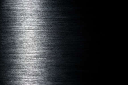 Texture of black polished anodized aluminum with light reflection on the left and free space on the rightの写真素材